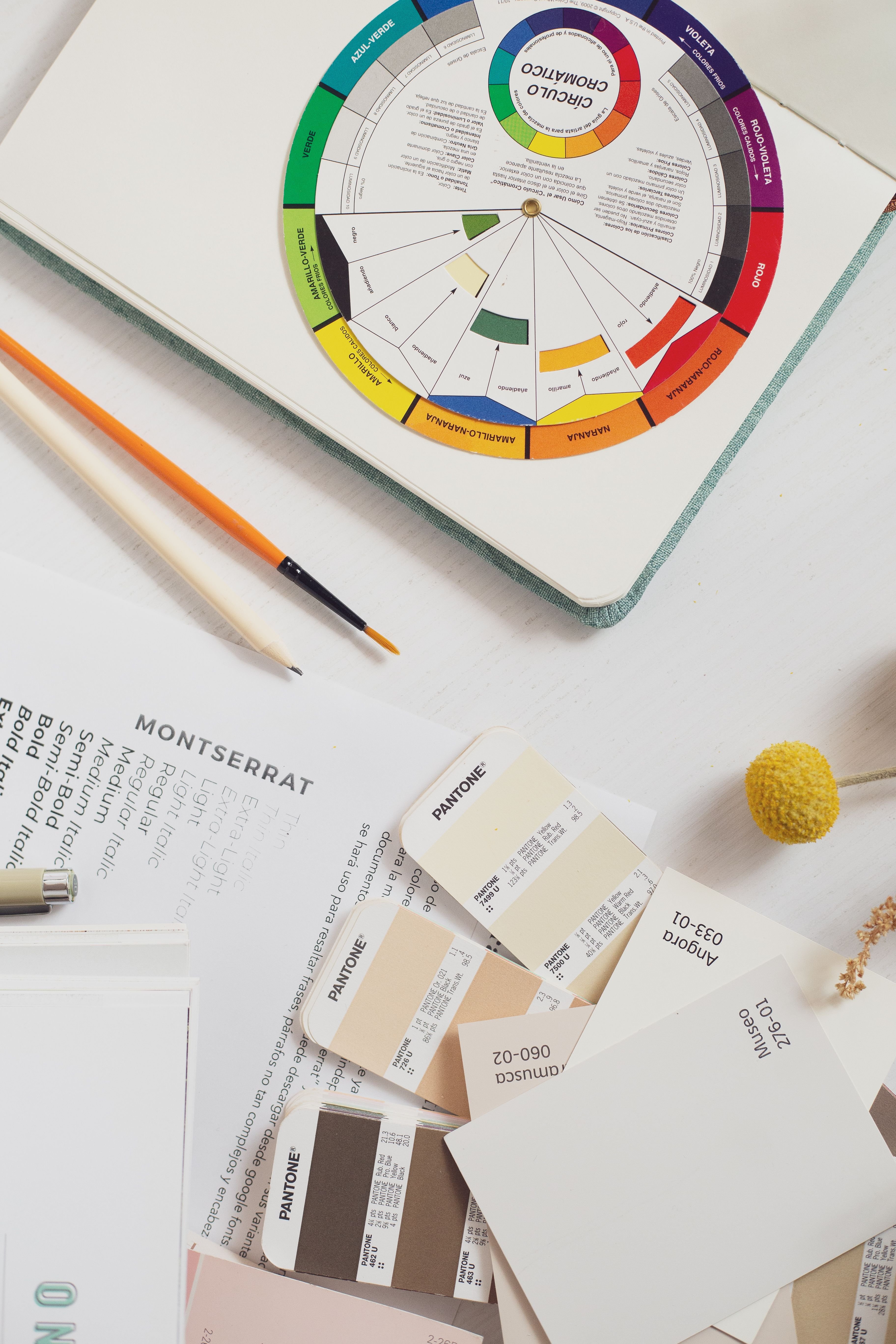 Color swatches, pencils, and design materials arranged on a creative workspace