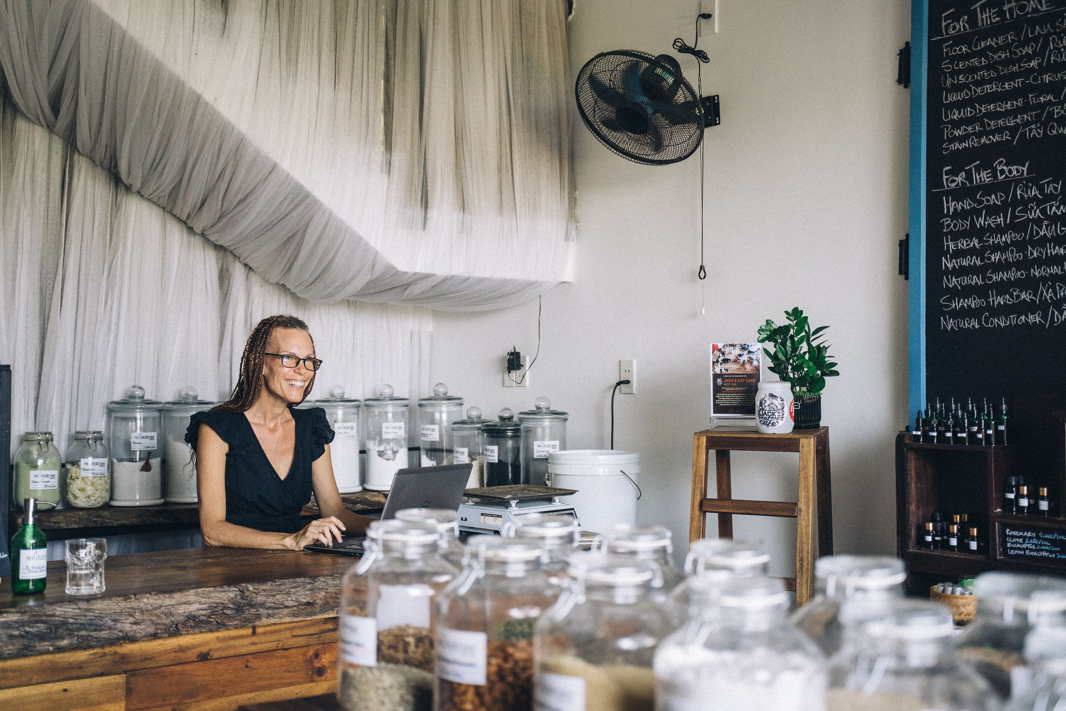 Small business owner working on a laptop inside an independent retail shop