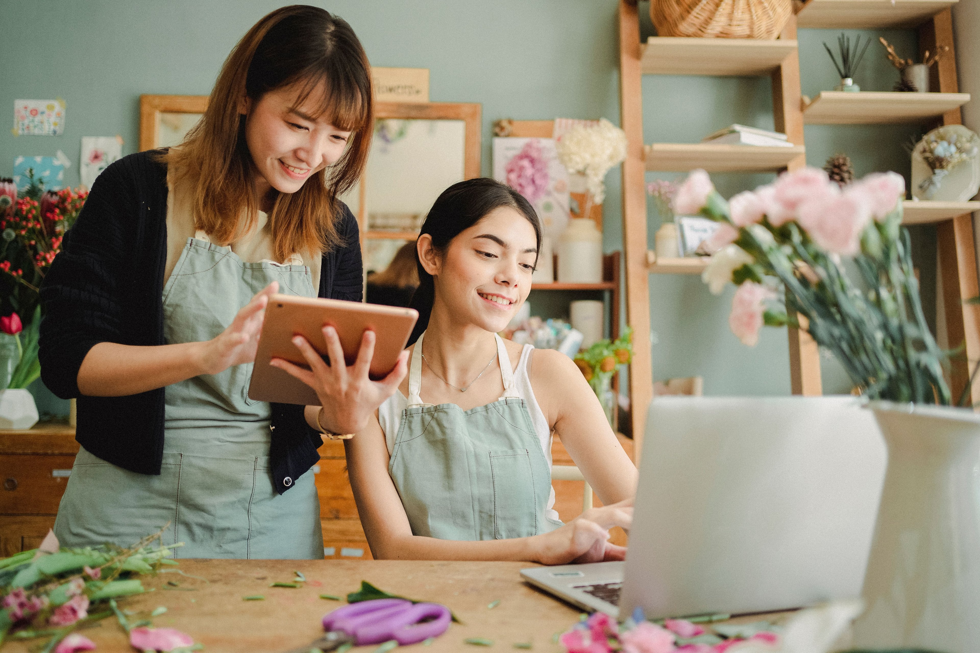 Florist working on a laptop inside a flower shop